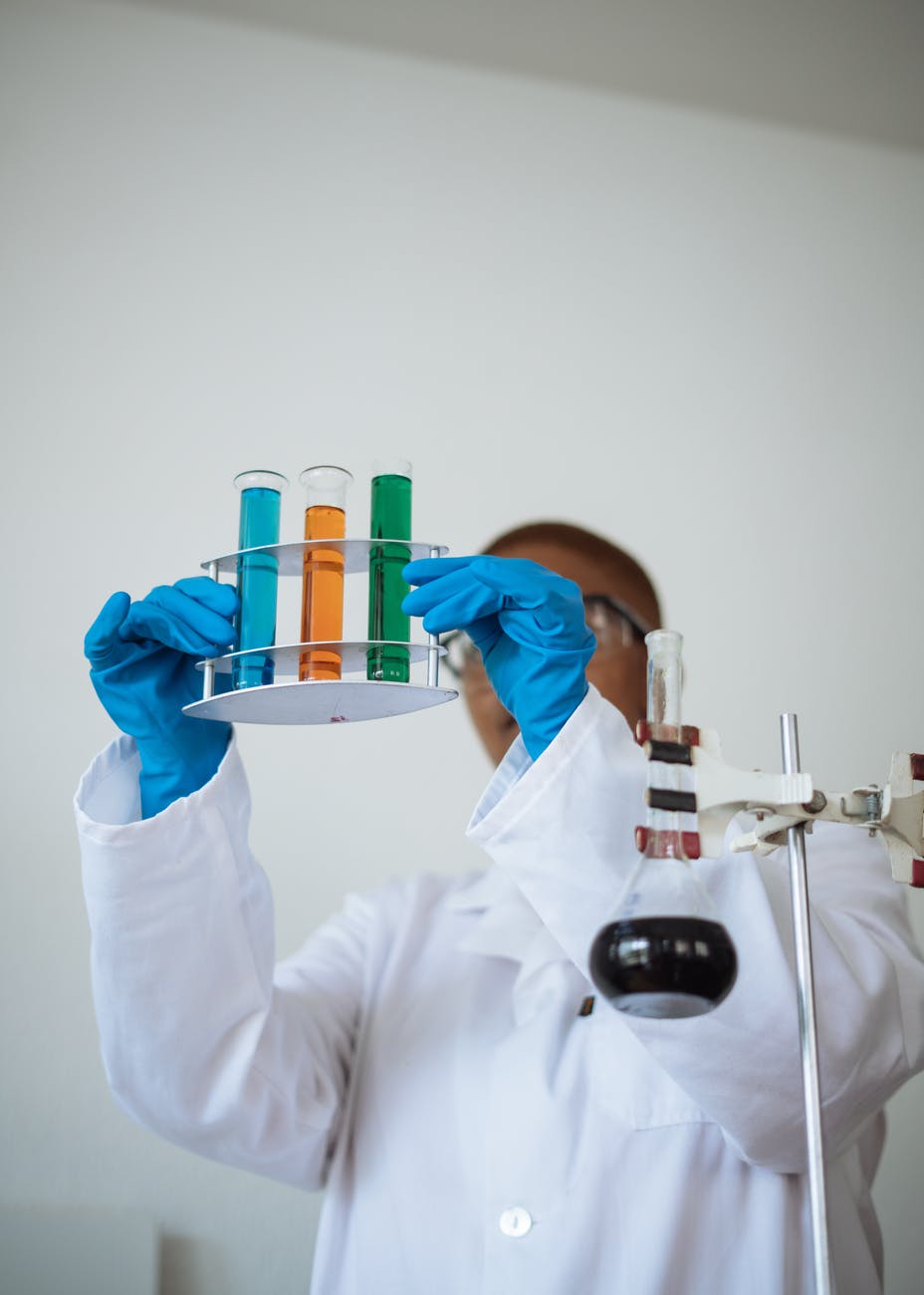 faceless scientist inspecting chemical samples in science center