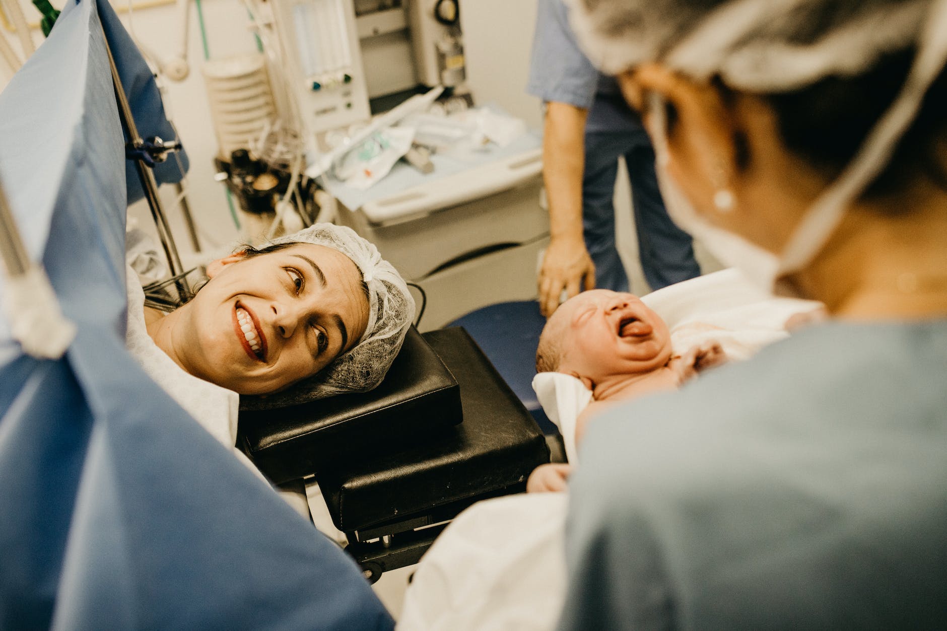 mother smiling looking at newborn child